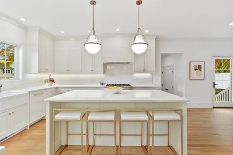 a kitchen with a table and chairs in it