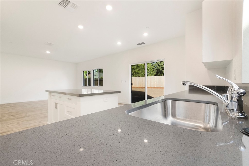 881 Bertino Place Chico, CA 95973 - Photo 16 of 55 a view of a kitchen with a sink and dishwasher with wooden floor