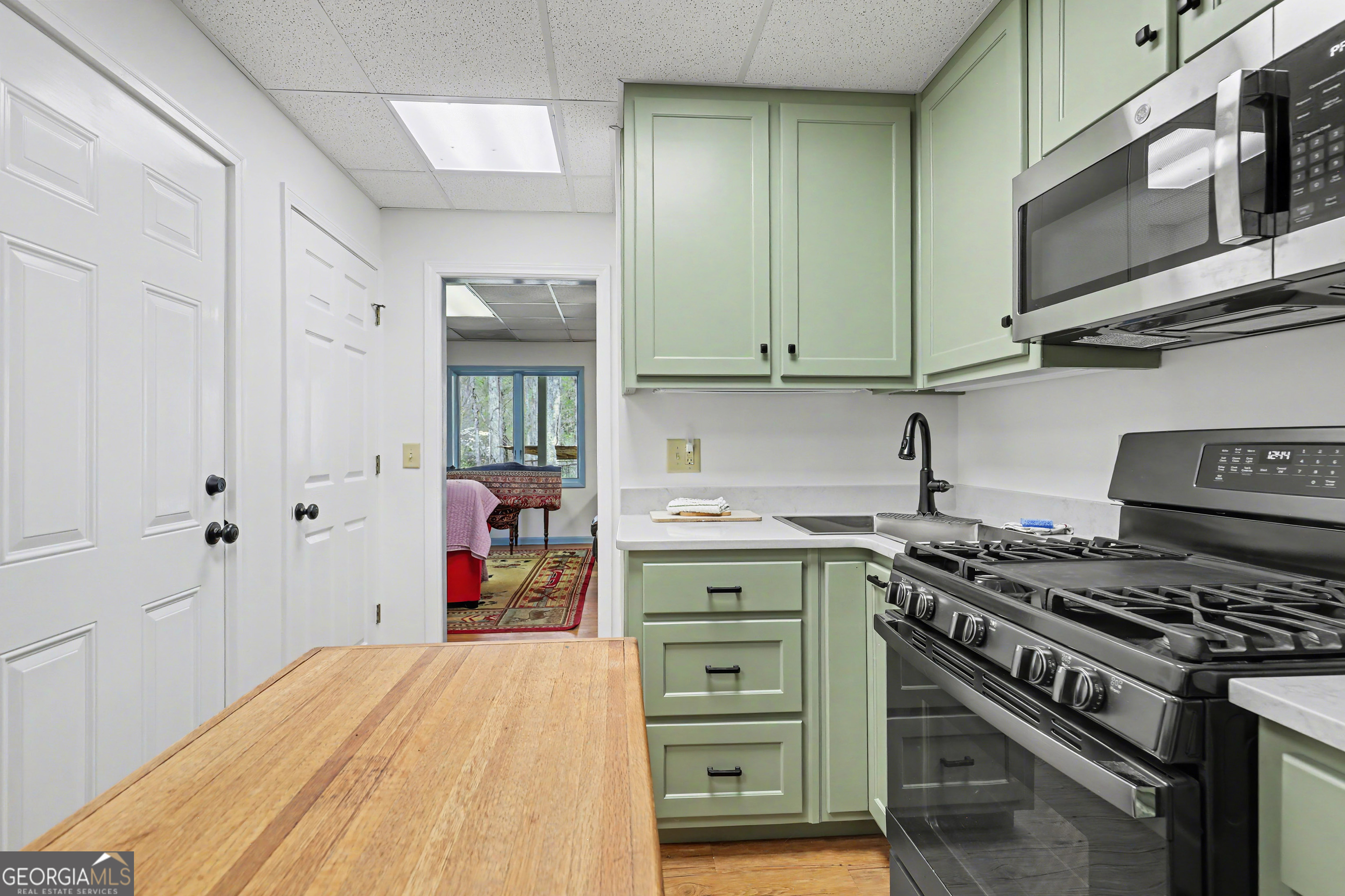 1067-o V Ov Justus Road Rabun Gap, GA 30568 - Photo 49 of 73 a kitchen with stainless steel appliances a stove and cabinets