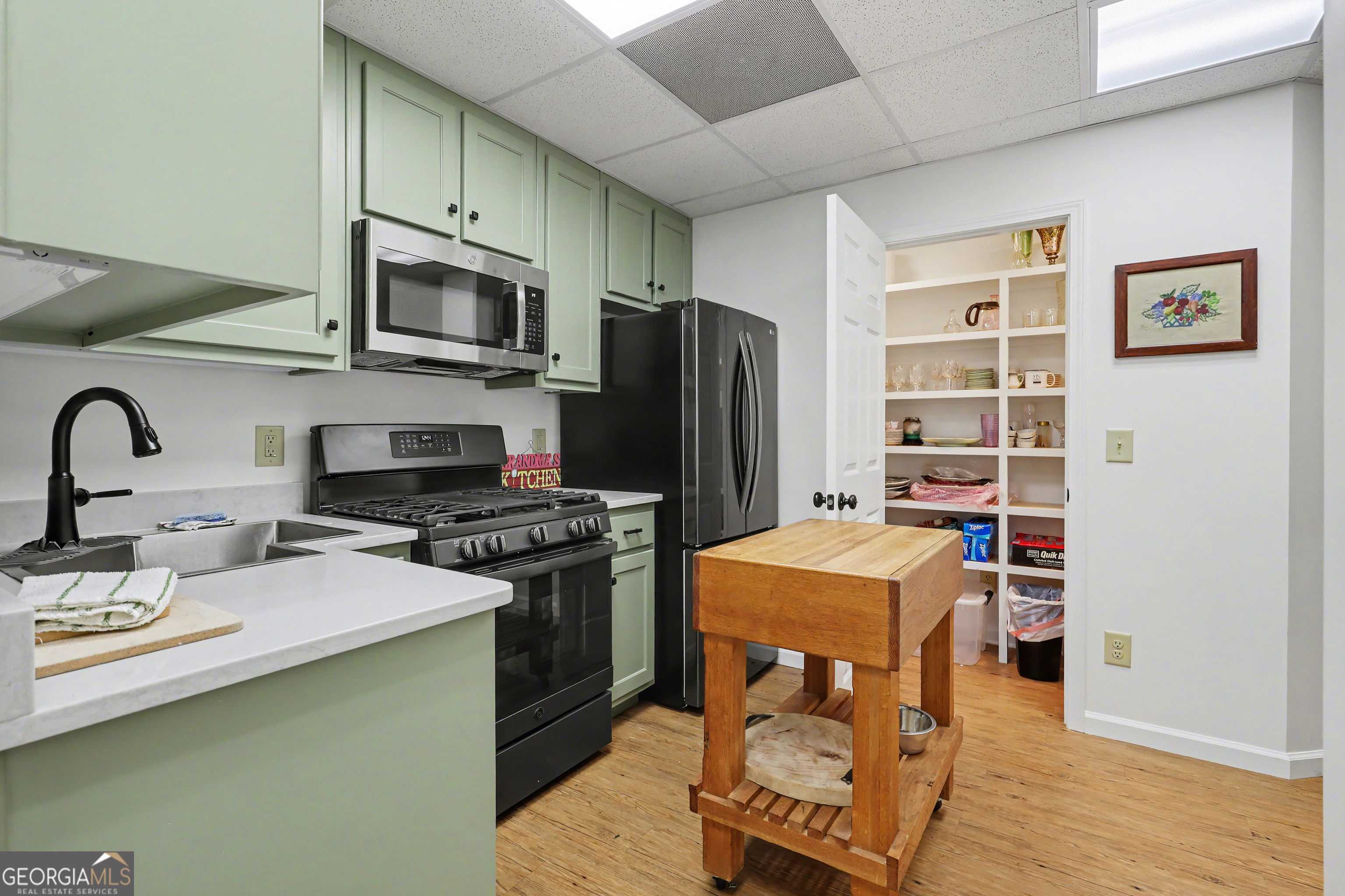 1067-o V Ov Justus Road Rabun Gap, GA 30568 - Photo 50 of 73 a kitchen with stainless steel appliances granite countertop a stove refrigerator sink and microwave