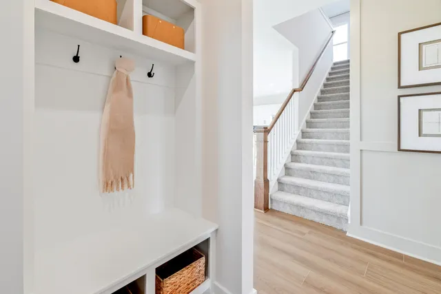 a view of a dining room with furniture and a potted plant