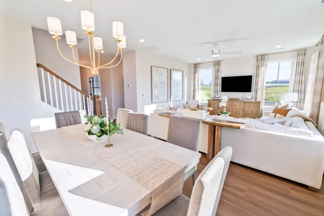 a living room with stainless steel appliances furniture and a large window