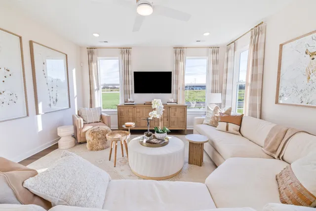 a living room with patio furniture and a flat screen tv