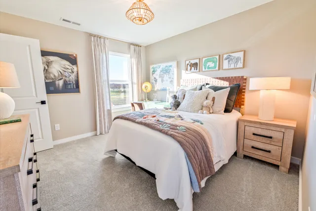 a bed sitting in a bedroom next to a window