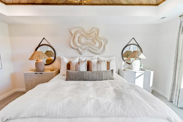 a bedroom with a bed and a painting on the wall