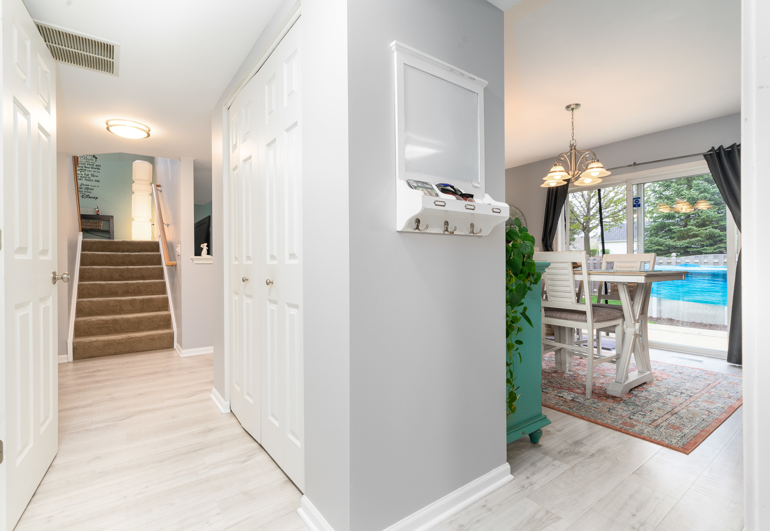 3626 Harms Road Joliet, IL 60435 - Photo 16 of 32 a hallway with painting and a chandelier