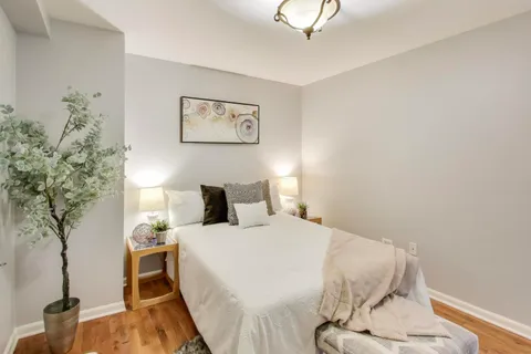 a bedroom with a bed and a potted plant