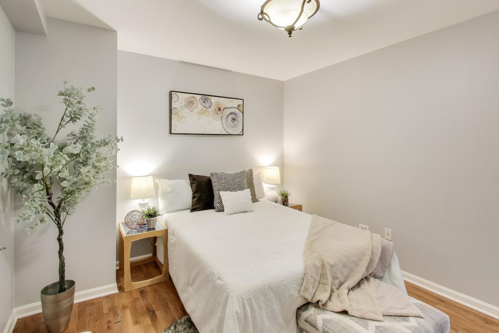 4212 North Ashland Avenue, Unit GS Chicago, IL 60613 - Photo 12 of 16 a bedroom with a bed and a potted plant