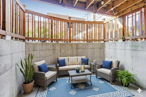 a living room with furniture and a potted plant