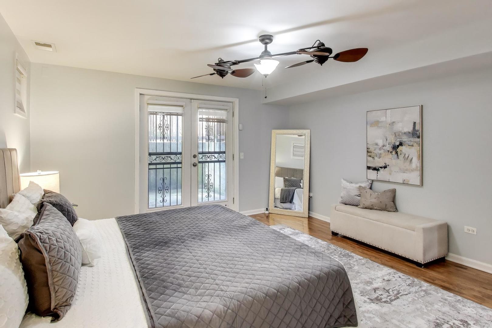 4212 North Ashland Avenue, Unit GS Chicago, IL 60613 - Photo 8 of 16 a bedroom with a large bed and a couch