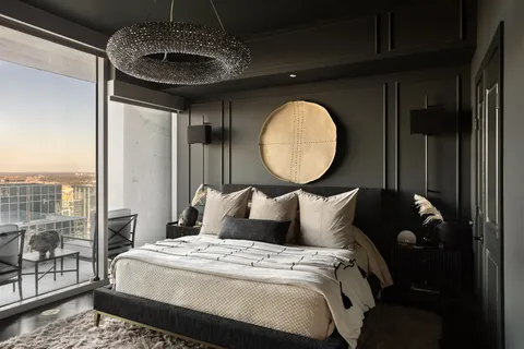 a bed sitting in a bedroom next to a window