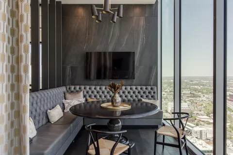 a view of a livingroom with furniture and floor to ceiling window