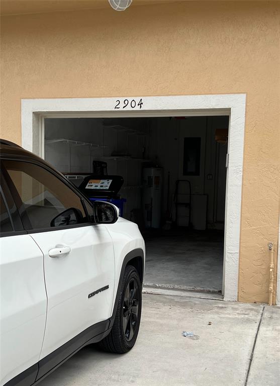 2904 Crestwood Terrace, Unit 4104 Margate, FL 33063 - Photo 20 of 21 a car parked in a garage