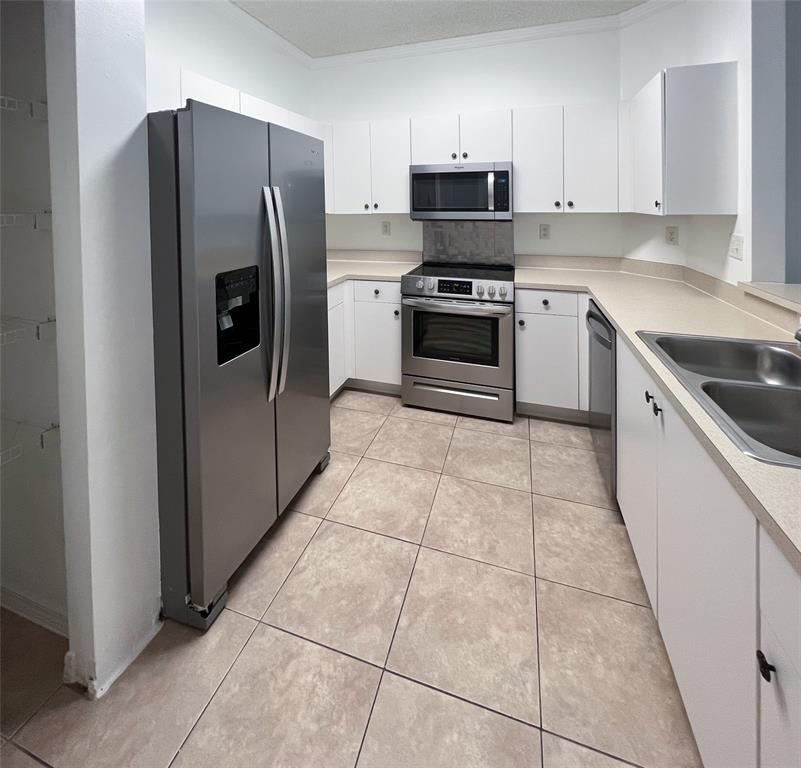 2904 Crestwood Terrace, Unit 4104 Margate, FL 33063 - Photo 4 of 21 a kitchen with stainless steel appliances granite countertop a stove a refrigerator and a sink