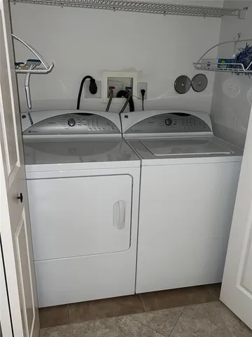 a view of an empty room with wooden floor and closet