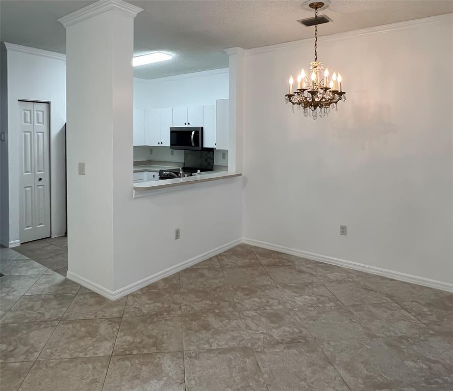 2904 Crestwood Terrace, Unit 4104 Margate, FL 33063 - Photo 10 of 21 a view of a kitchen with a sink and a chandelier