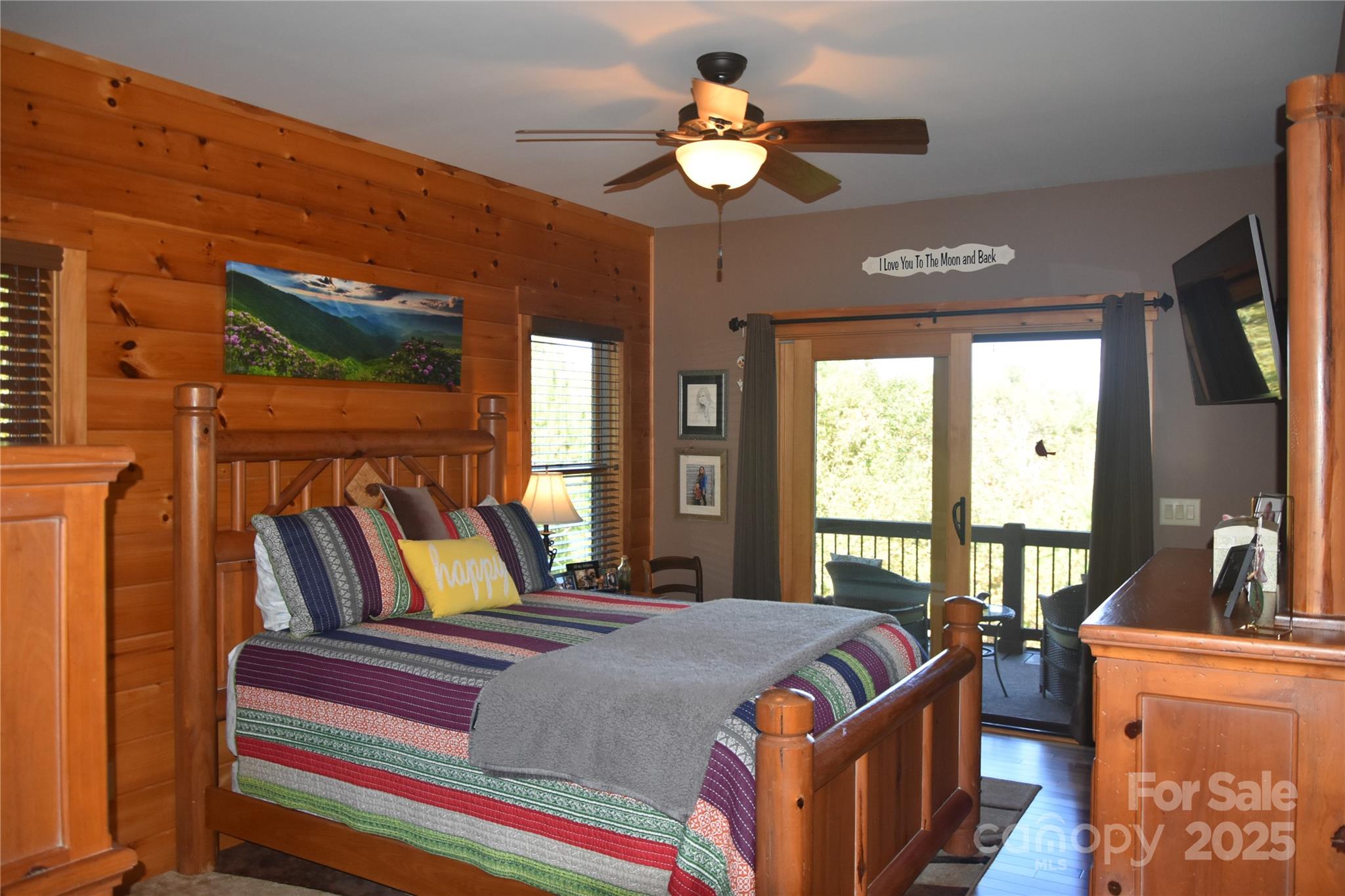 80 Grandview Loop Nebo, NC 28761 - Photo 21 of 42 a bedroom with a large bed a flat tv screen and a chandelier