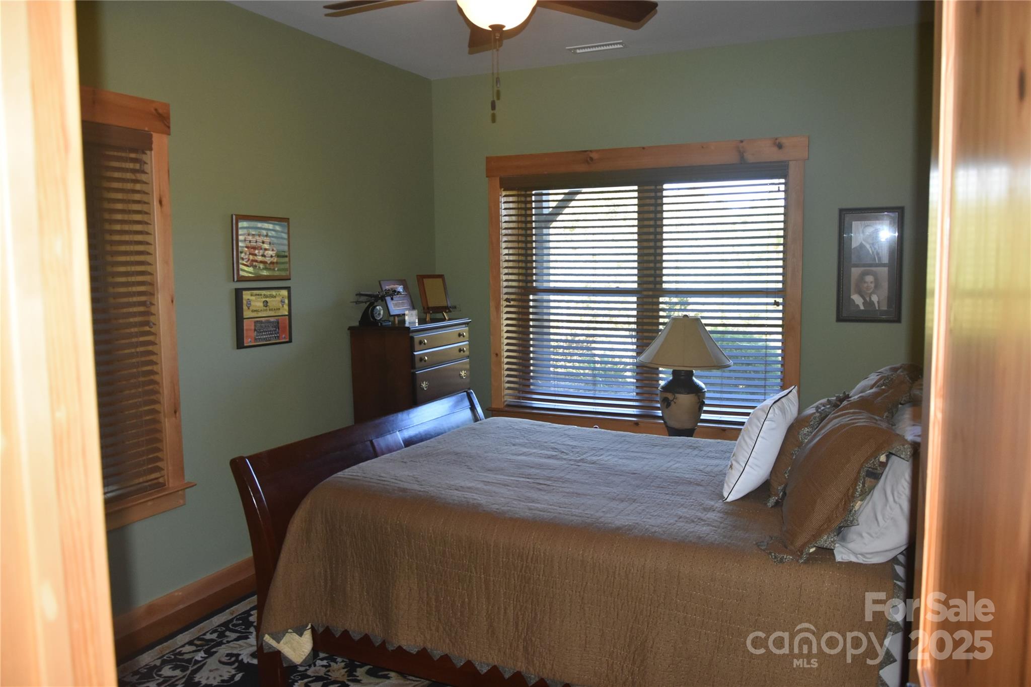 80 Grandview Loop Nebo, NC 28761 - Photo 30 of 42 a bedroom with a bed and a chandelier