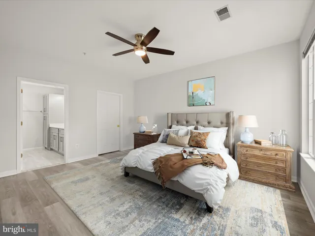 a bedroom with a large bed and a chandelier