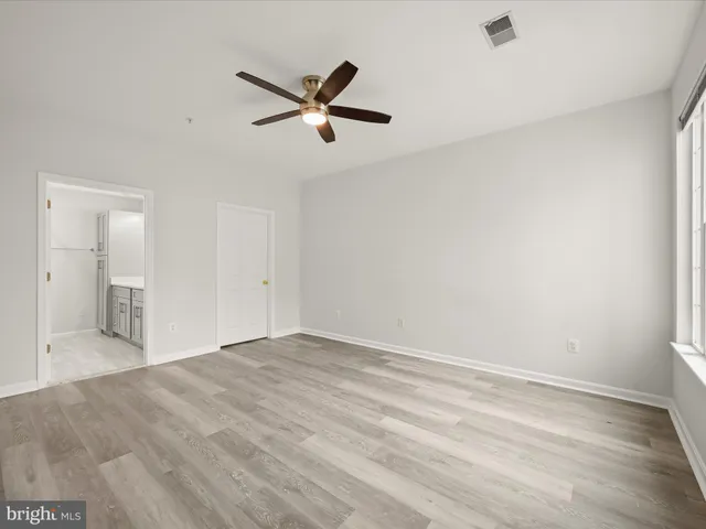a view of a livingroom with a ceiling fan and wooden floor