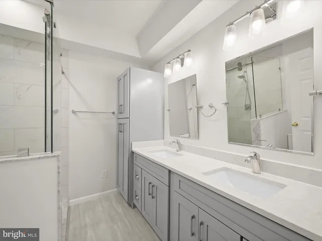a bathroom with a double vanity sink mirror and double