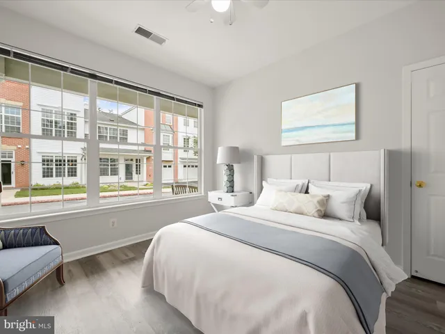 a bedroom with a large bed and a large window