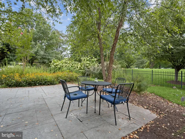 a view of swimming pool with a garden and plants