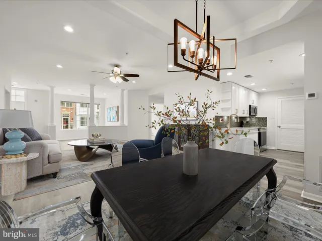 a view of a dining room with furniture and a chandelier