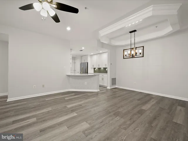 a view of a kitchen with a dishwasher cabinets and wooden floor