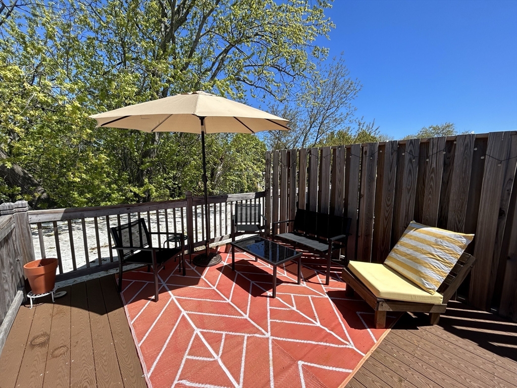 a view of a roof deck with wooden floor and fence