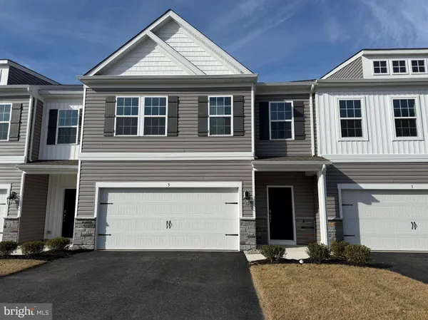 a front view of a house with garage