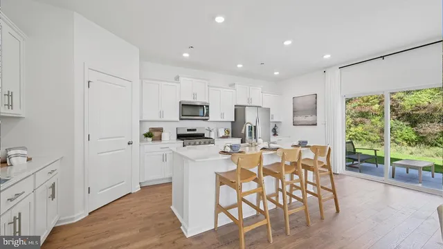 a dining room with furniture a chandelier and wooden floor