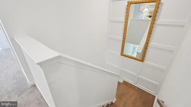 a living room with furniture kitchen view and a chandelier