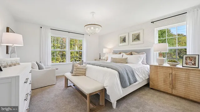 a spacious bedroom with a bed and a large window