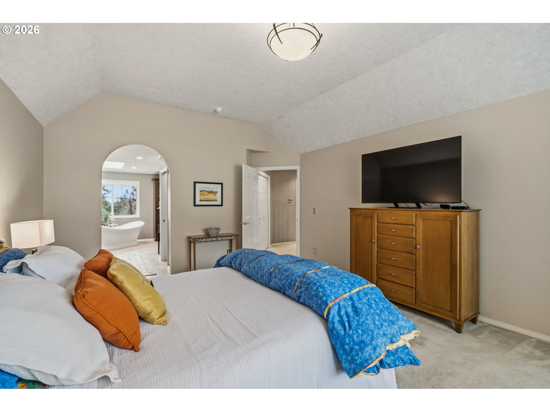 6108 Southwest Kruse Ridge Drive Portland, OR 97219 - Photo 22 of 42 a bedroom with a bed and a flat screen tv