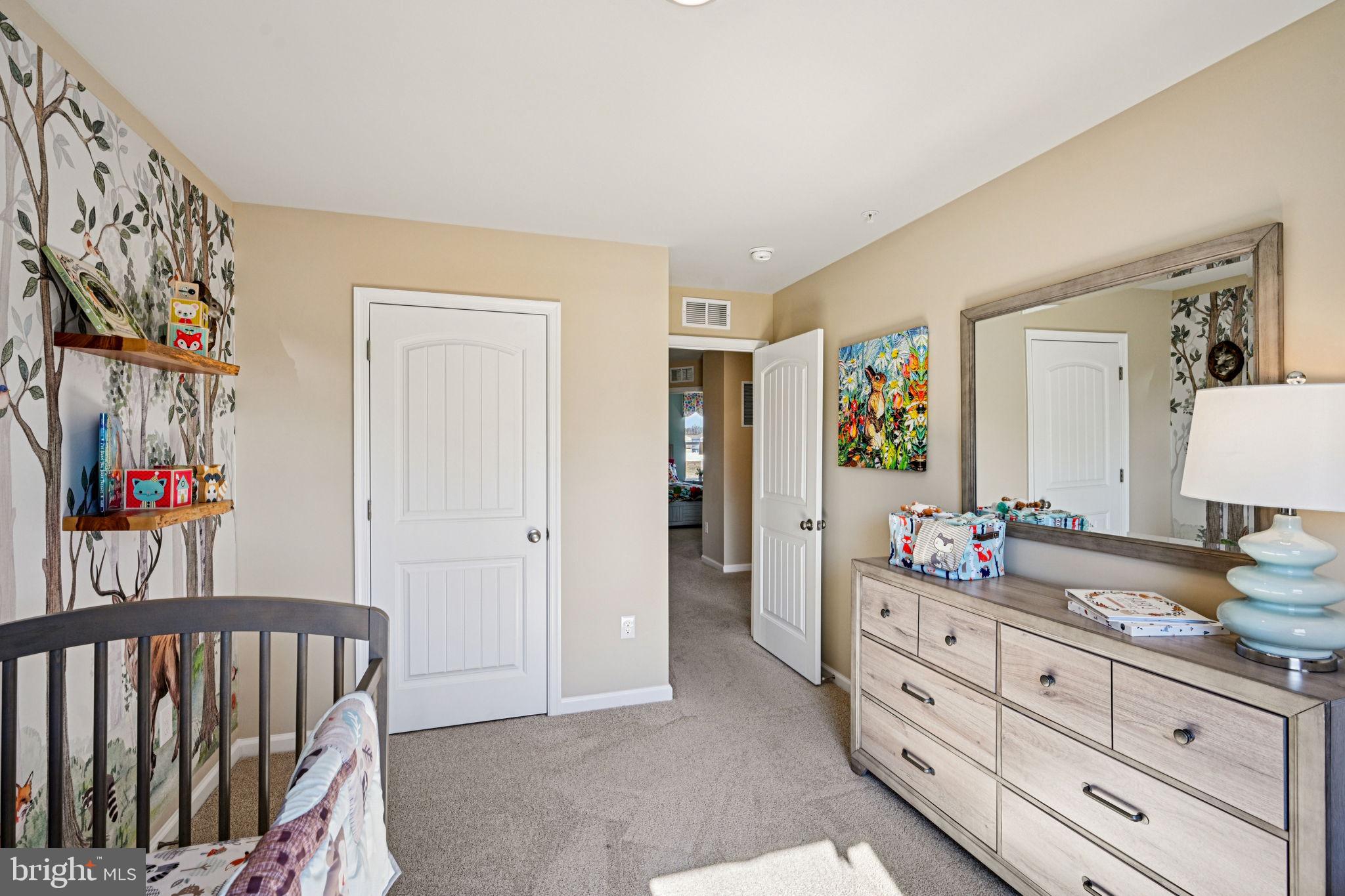 1153 Wintermead Loop Salisbury, MD 21801 - Photo 22 of 33 a bedroom with furniture and a mirror