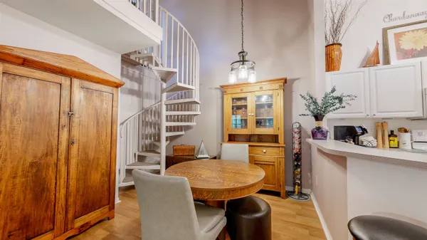 a kitchen with stainless steel appliances a table and chairs in it