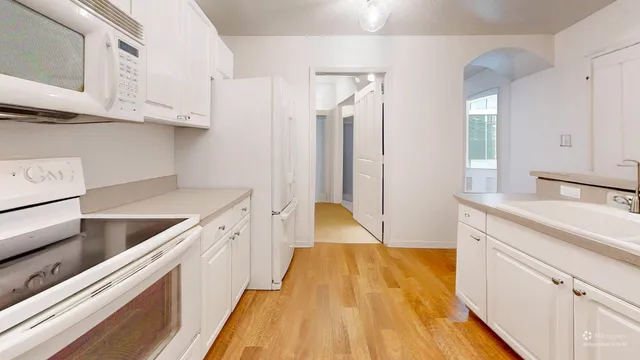 a kitchen with stainless steel appliances granite countertop a sink and wooden cabinets