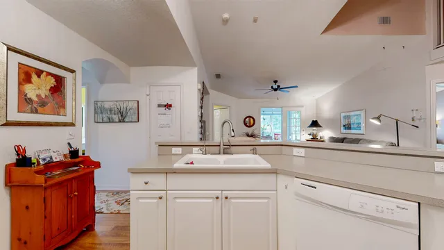 a kitchen with white cabinets and white appliances