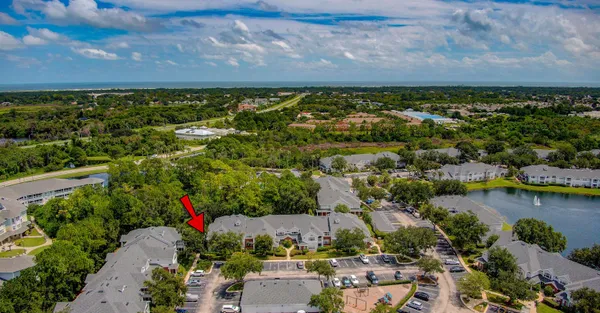 an aerial view of residential building and lake