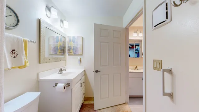 an empty room with a window and a ceiling fan