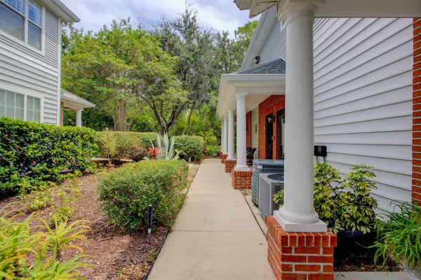 a view of a house with potted plants and more windows
