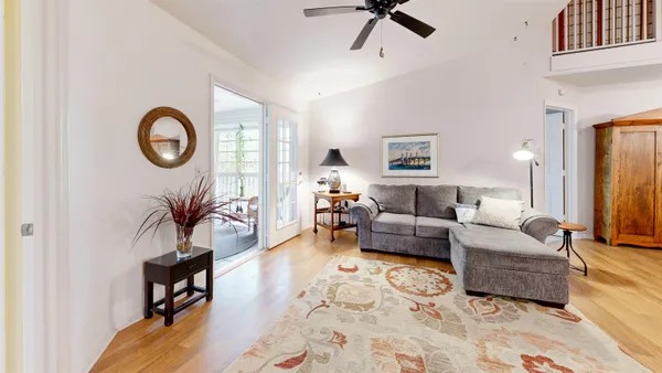 a living room with furniture and a wooden floor