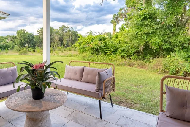 a view of a patio with swimming pool and furniture