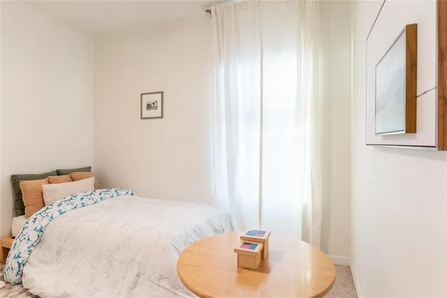 a bedroom with a bed and a mirror