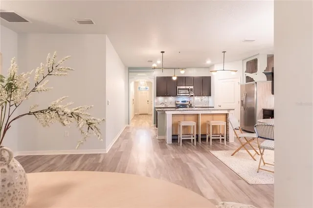 a living room with stainless steel appliances kitchen island granite countertop furniture and a kitchen view