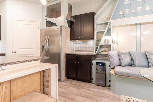 a kitchen with stainless steel appliances granite countertop a refrigerator and a sink