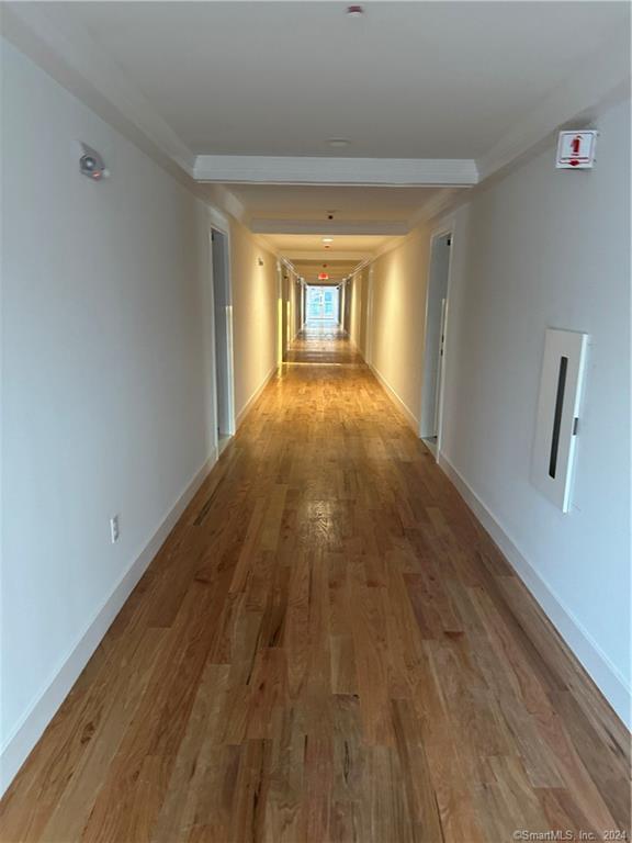 a view of hallway with wooden floor