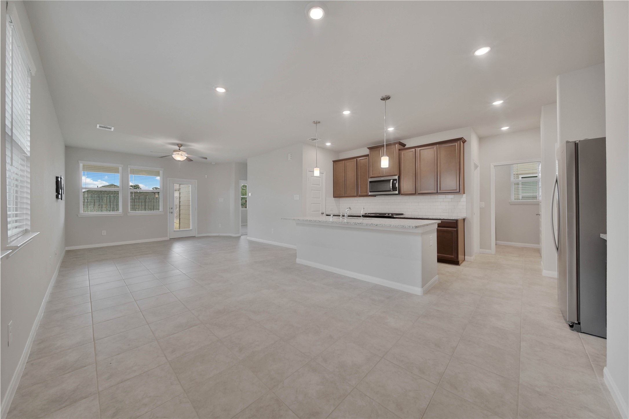 7080 Silverleaf Oak Street Conroe, TX 77304 - Photo 34 of 35 The open floorplan offers the best in flexible living space. You'll appreciate the easy care tile floors.