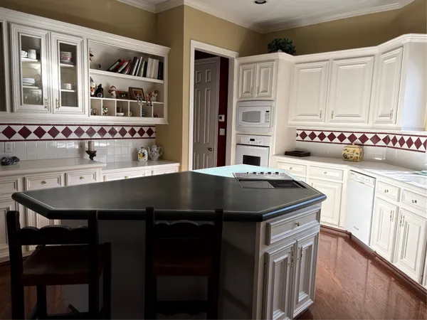 a kitchen with stainless steel appliances granite countertop a sink and cabinets